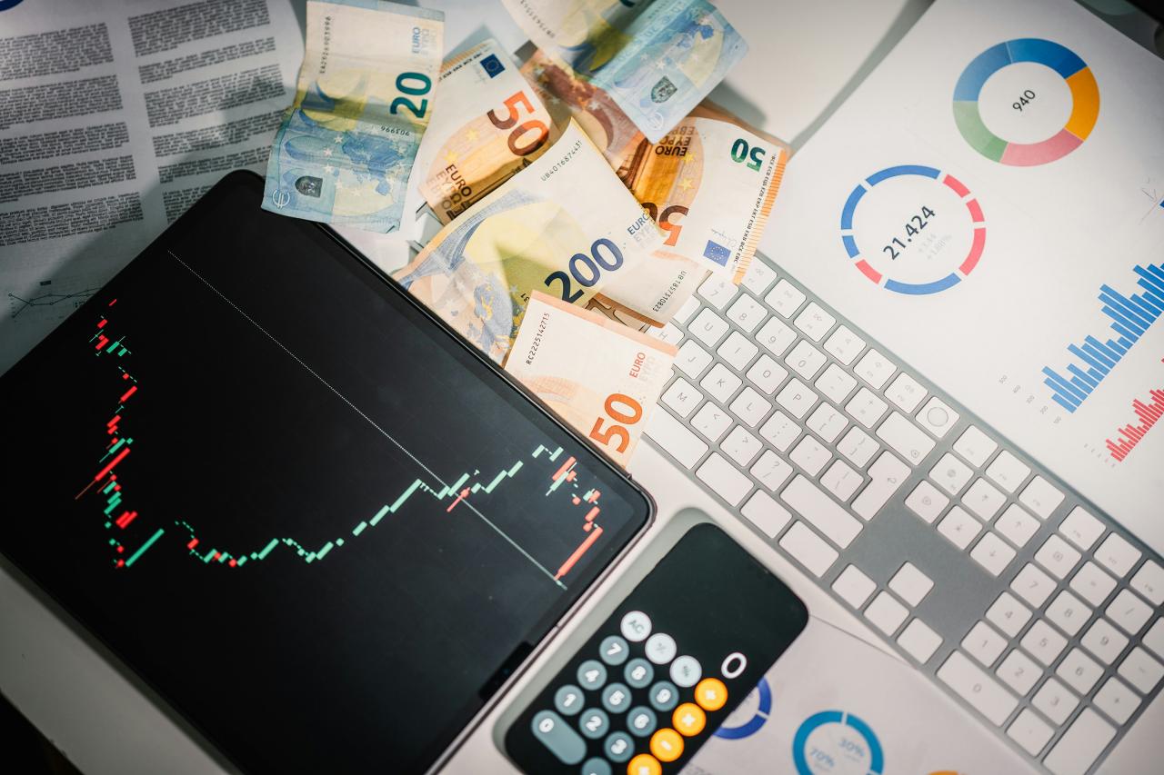 A calculator sitting on top of a pile of money